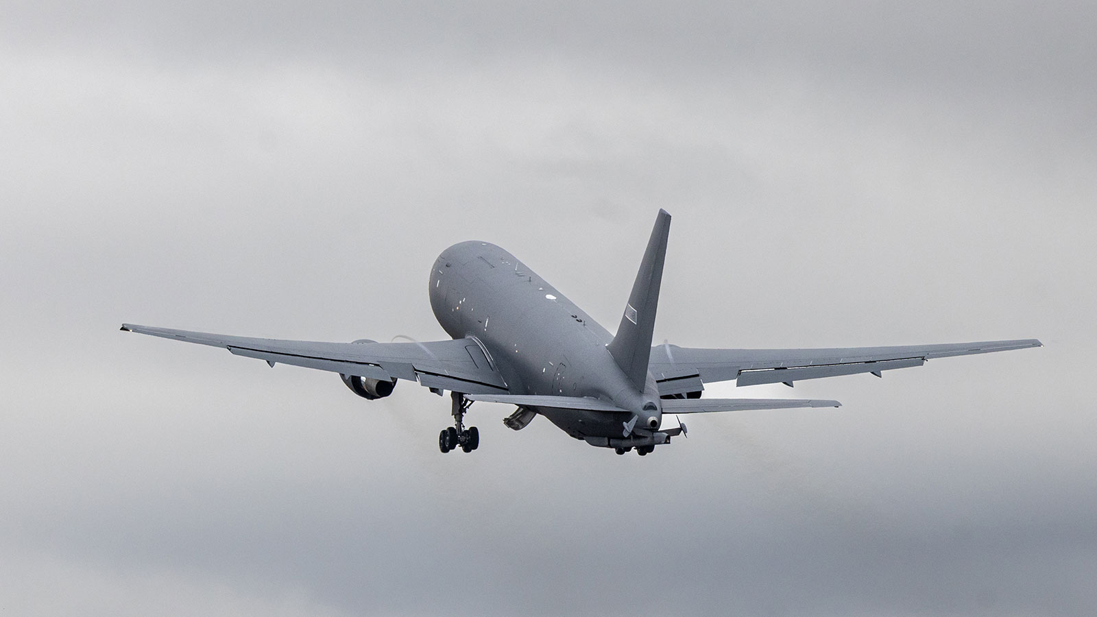 Gray tanker flying away