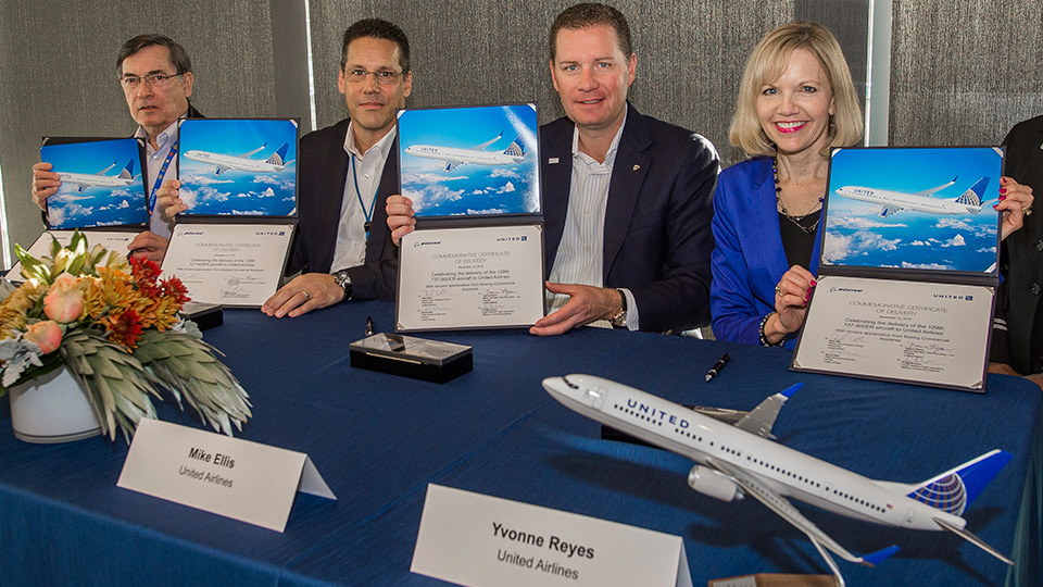 United Airlines officials hold proof of 737-900ER delivery