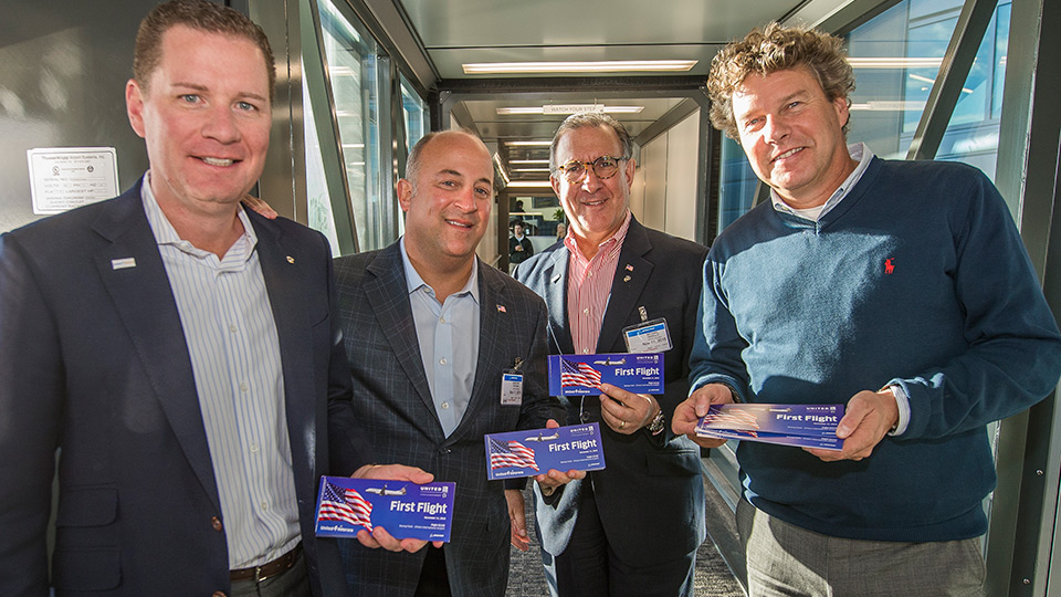 United employees hold boarding passes for new 737-900ER.