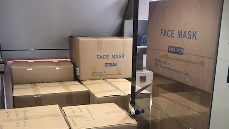 Medical-grade face mask boxes in airplane cargo hold