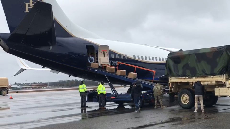 Boxes of medical masks offloading from Boeing Business Jet