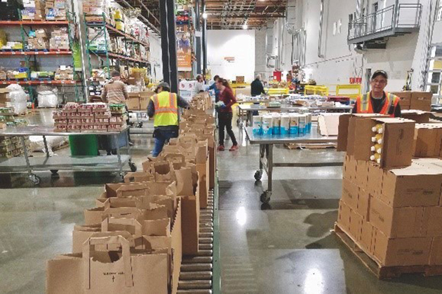 The Food Lifeline warehouse with staff and volunteers maintaining social distance 