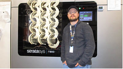 Joshua Dunn standing with face shield frames