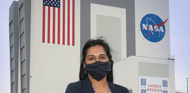 Suba Iyer, SLS Launch Integrated Product Team lead for Boeing, in front of the Vehicle Assembly Building