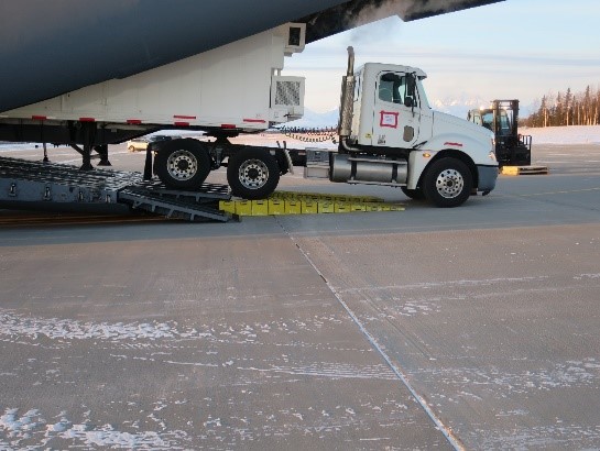 Semitrailer loads cargo into C-17 using new loading ramp