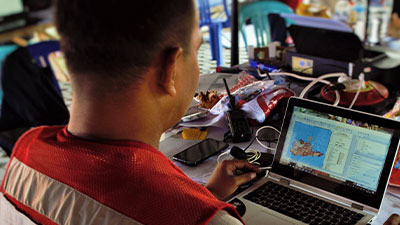 Man with open-source geospatial data on laptop