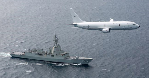The Royal Australian Air Force’s first P-8A Poseidon flies over Air Warfare Destroyer HMAS Hobart.