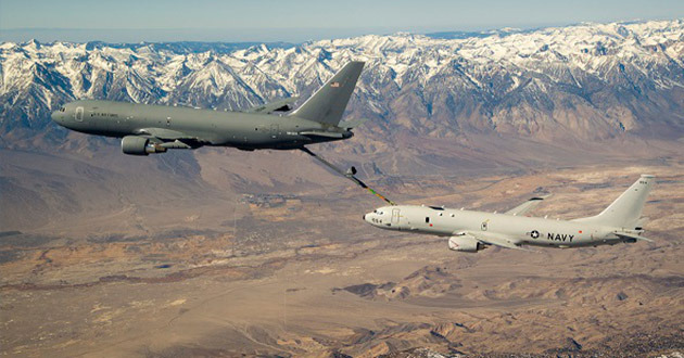 Fitted with an in-flight refueling system, a U.S. Navy P-8A practices refueling with a KC-46A tanker over the mountains of Southern California.