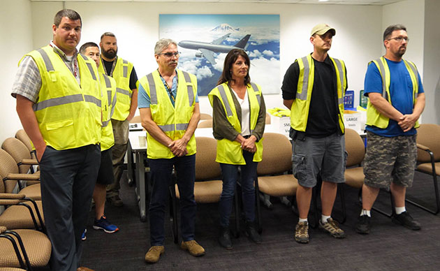 Boeing team members who build the KC-46A at the Everett Modification Center listen to Brig. Gen. Charles B. McDaniel's remarks before his final flight.