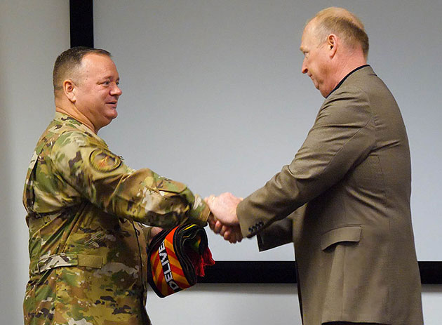 Boeing KC-46 business development manager Mike Hafer congratulates U.S. Air Force Brig. Gen. Charles B. McDaniel before his final flight on 31 years of service.