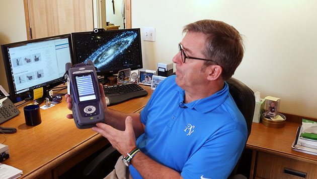 PSI Solutions president Tad Papineau displays a piece of ground support test equipment his company supplies for the KC-46A Pegasus.
