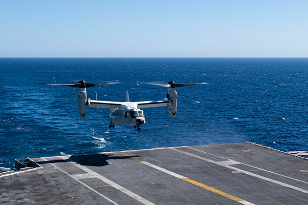 The CMV-22 lands on the flight deck of an aircraft carrier.