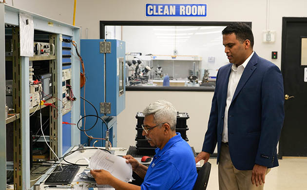 Production manager Carlos De Santiago (left) and chief operating officer Donovan Rodrigues (right) examine pressure sensor test results. 