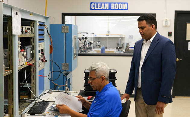 Production manager Carlos De Santiago (left) and chief operating officer Donovan Rodrigues (right) examine pressure sensor test results.