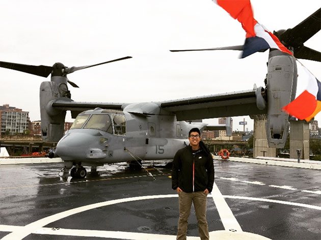  Reg Torrevillas with a V-22 Osprey in 2016, just months after being hired as a design engineer.