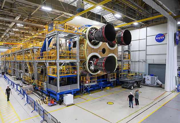 Teams are shown installing the third RS-25 engine on Core Stage 2
