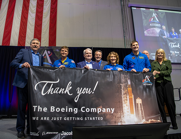 NASA presented Artemis appreciation banner to Boeing. Left to right: Mike Sarafin (NASA), Reid Wiseman (NASA Astronaut), Dave Dutcher (Boeing), Steve Snell (Boeing), Christina Koch (NASA Astronaut), Jeremy Hansen (NASA Astronaut), John Honeycutt (NASA), Julie Bassler (NASA)
