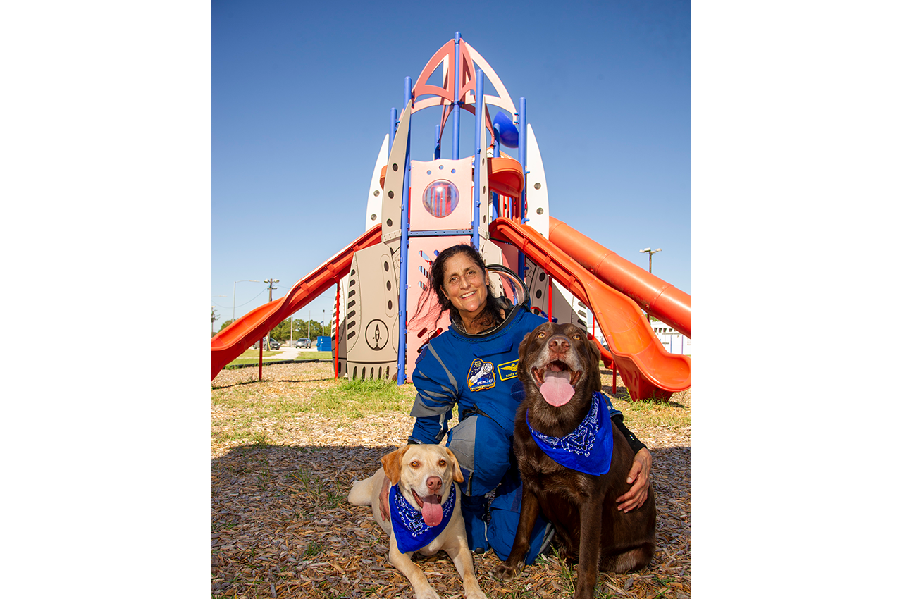 Suni Williams poses with her dogs Rotor, left, and Gunner.