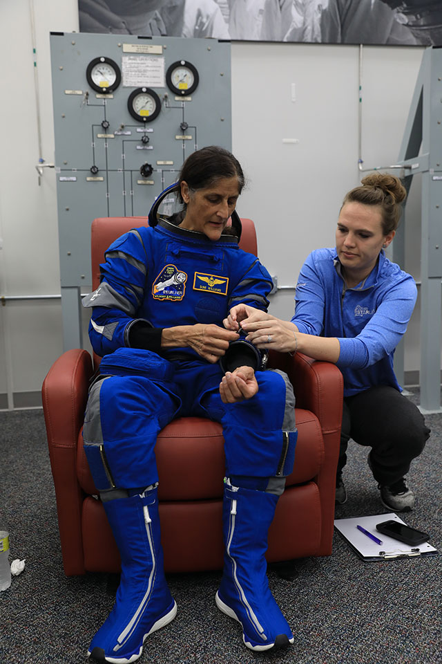 NASA astronaut Suni Williams, pilot for Boeing’s Crew Flight Test, checks her spacesuit during a crew validation test along with Tori Wills Pedrotty.