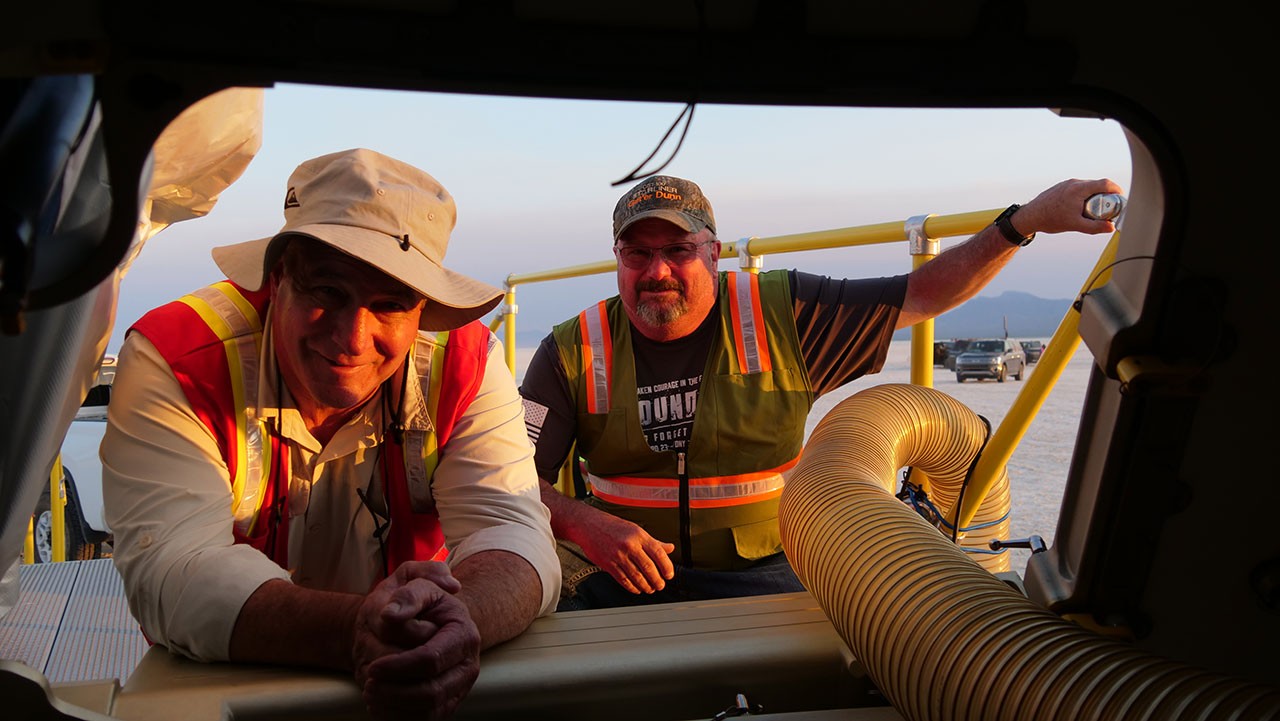 Calvin Dunn, right, and Daniel Quinn outside Starliner after it landed in New Mexico following Orbital Flight Test-2.