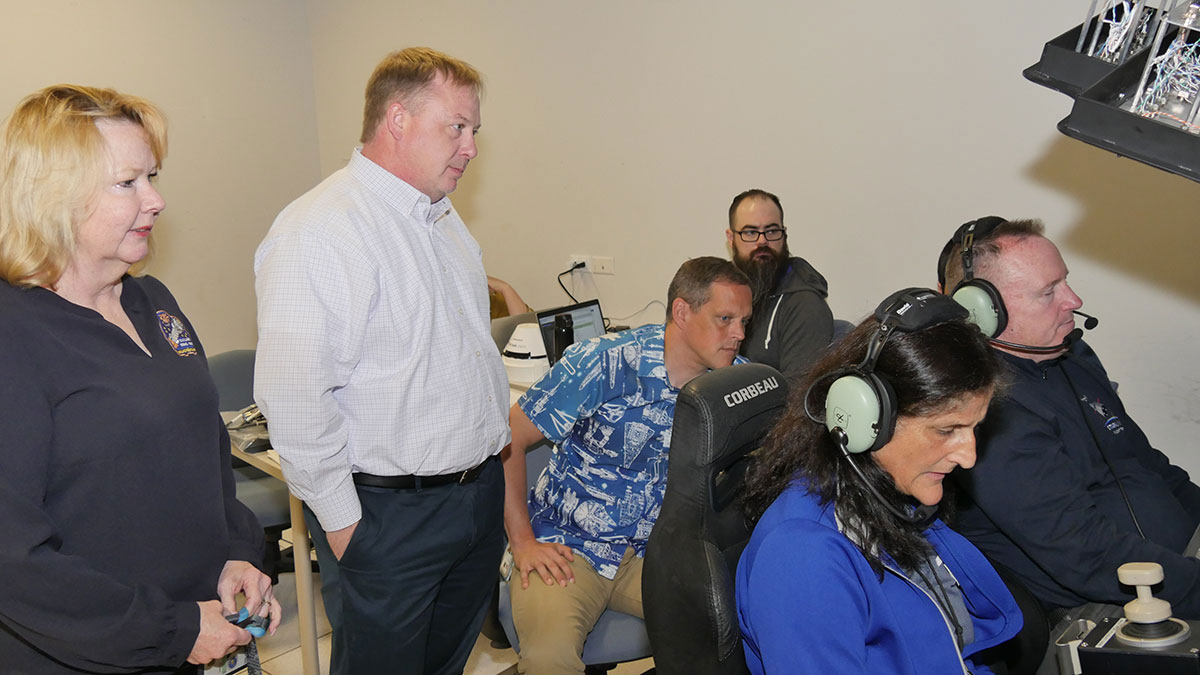Boeing’s Terri Puckett (from left) and Aaron Kraftcheck, along with NASA astronaut Bob Hines and NASA’s Eric Prehn, observe NASA astronauts Suni Williams and Butch Wilmore in Boeing’s Avionics and Software Integration Lab in Houston in April 2023.