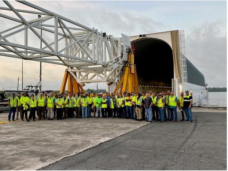 Boeing team stands in front of test article used for dress rehearsals for rollout