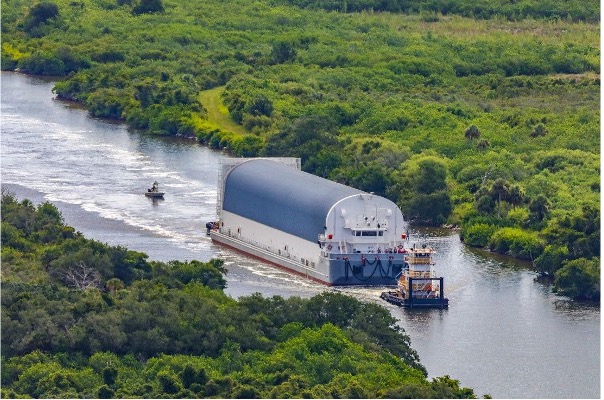 Core Stage 2, inside of the Pegasus barge, is transported down the canal. 
