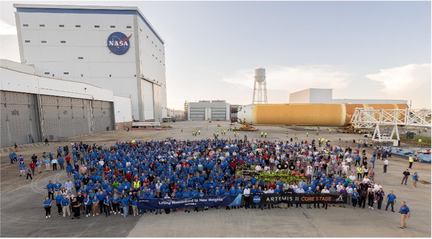 Boeing teammates plus NASA and other partners take a “family photo” with the Artemis II core stage as it rolls away from the assembly building at NASA's Michoud Assembly Facility in New Orleans, Louisiana. (NASA photo) 