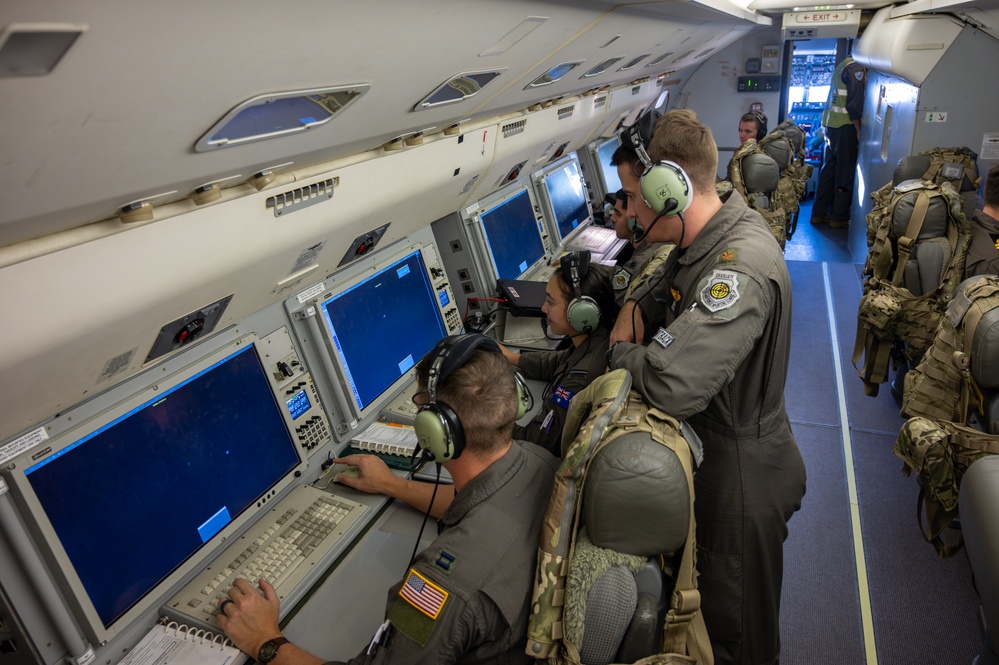 U.S. and RAAF crew members at mission consoles inside an E-7A Wedgetail 