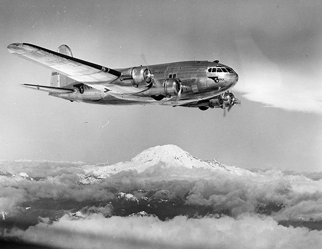 1940: As the age of commercial air travel blossomed, Boeing altered the design of the B-17 to produce the Boeing Model 307 Stratoliner, the first passenger airplane with a pressurized cabin. There is our regular guest making an appearance during the test flight. Only 10 were built.