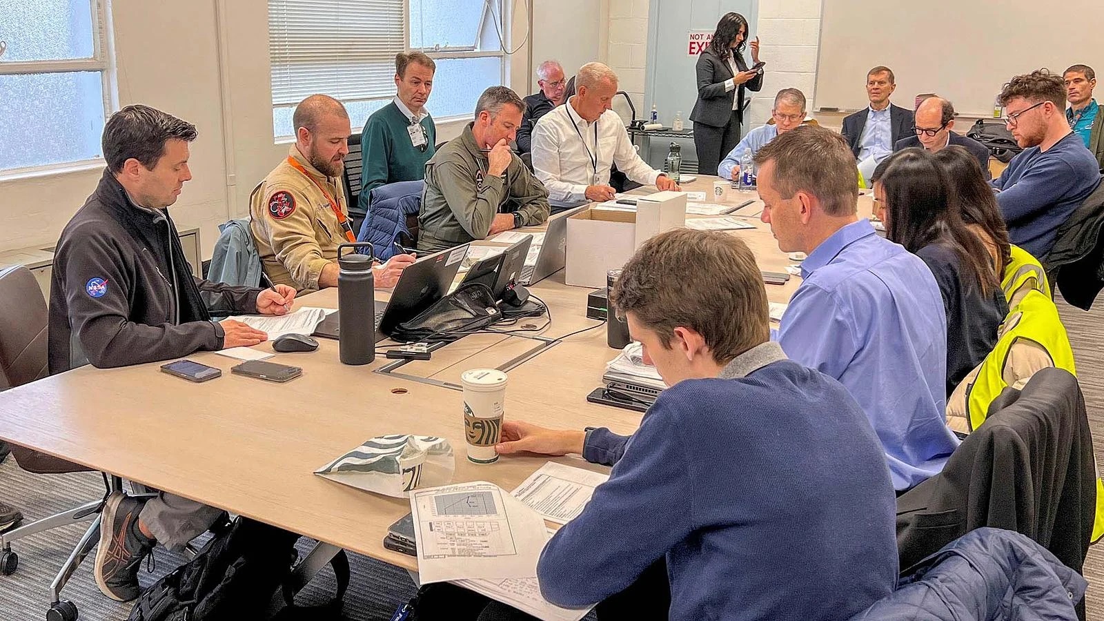 Boeing and NASA team members in a meeting 