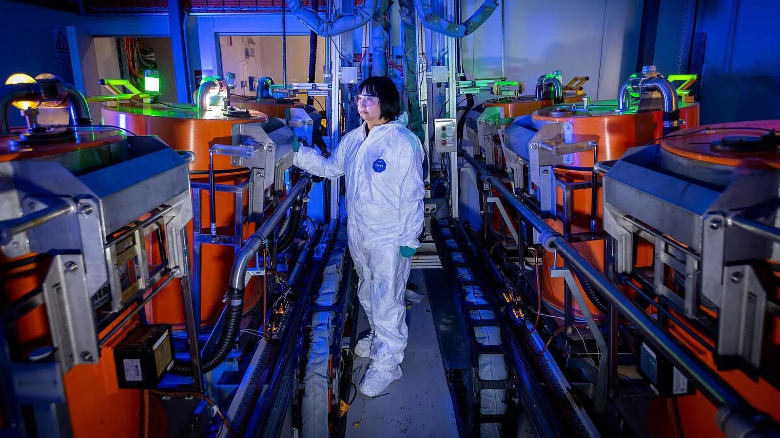 READY TO MIX: Tian inspects the automated resin mixing system before starting the mixing process. (Photo: Bruce Gibson, Boeing)