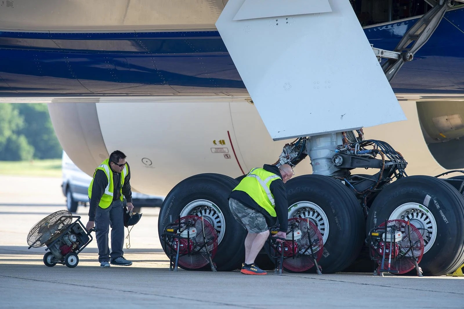 Flight-test teammates Brian Pham (left) and Drew Kemp position fans to cool the 777-9’s wheels and brakes after testing to allow consecutive test conditions to be completed.