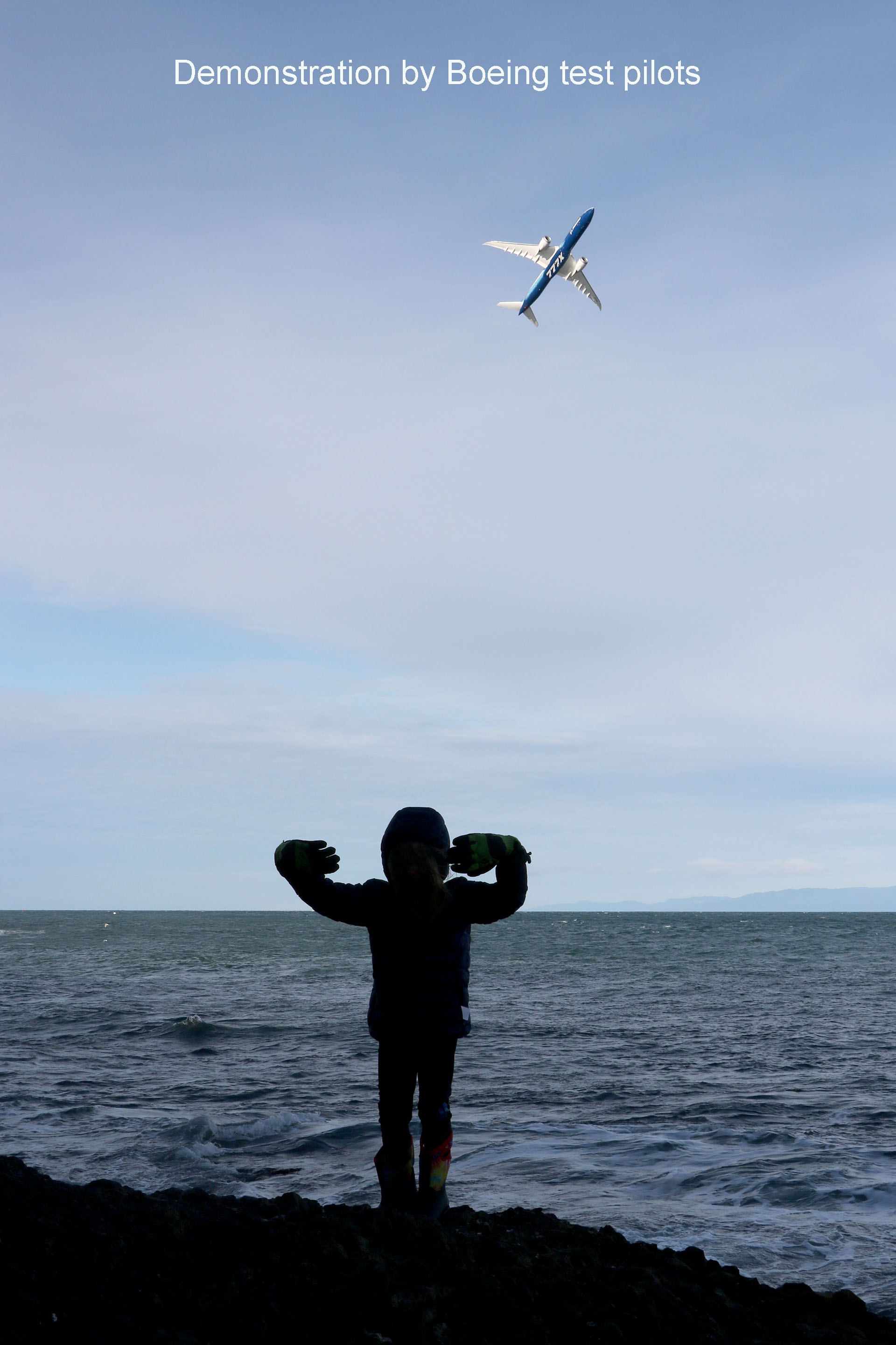The 5-year-old daughter of Sean Richardson, a flight-test engineer, cheers on a 777-9 air show demonstration practice flight.