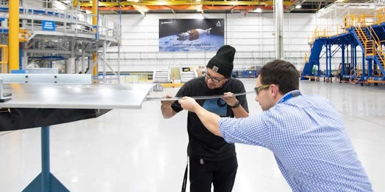 James Cenance and Sean Stockfish insert load panels to the test article.