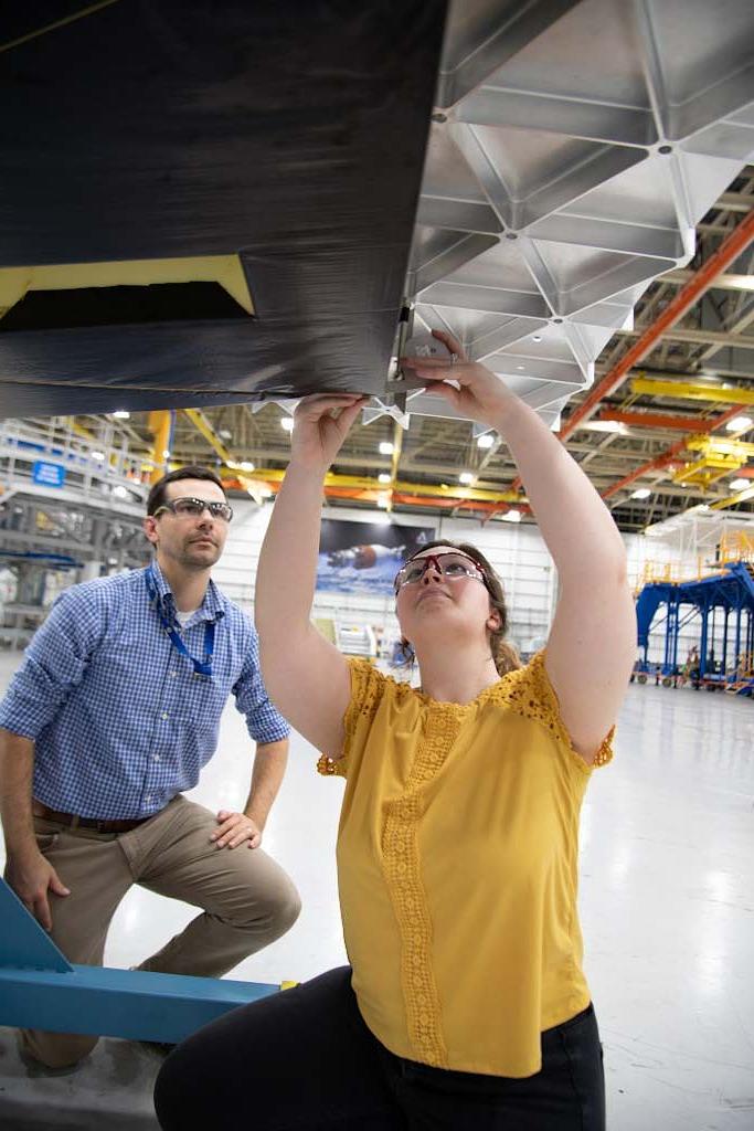 Brooke Merenuk and Sean Stockfish inspect and measure the angles necessary to calculate safety factors for flight.