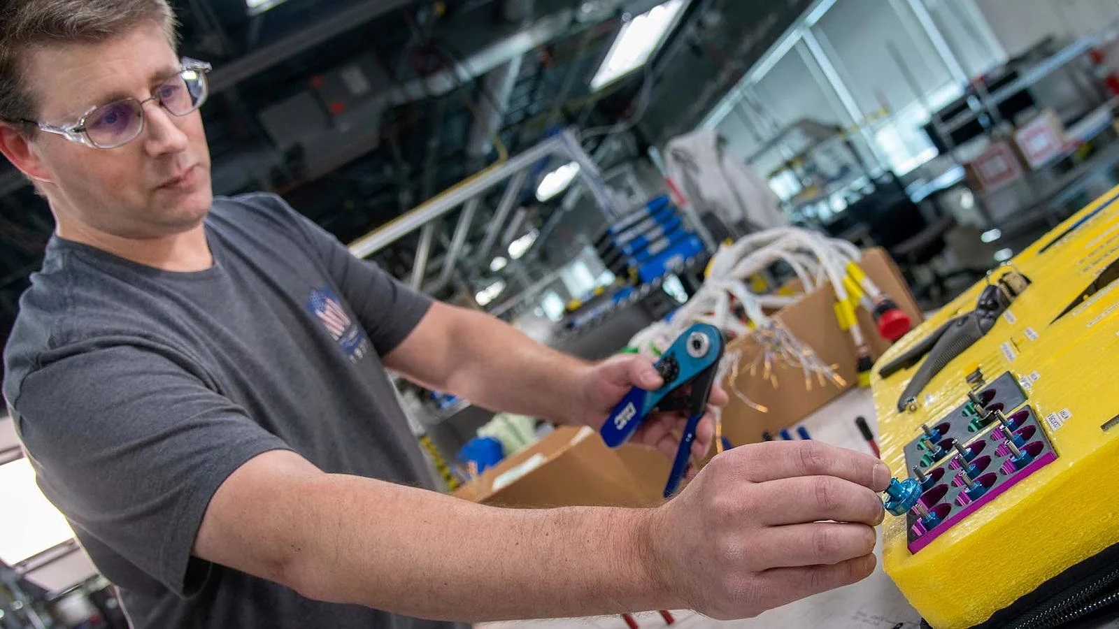 Thomas Vannoy, a 767 Freighter team lead at the Electrical Systems Responsibility Center, places a locator tool into the 3D-printed tray.