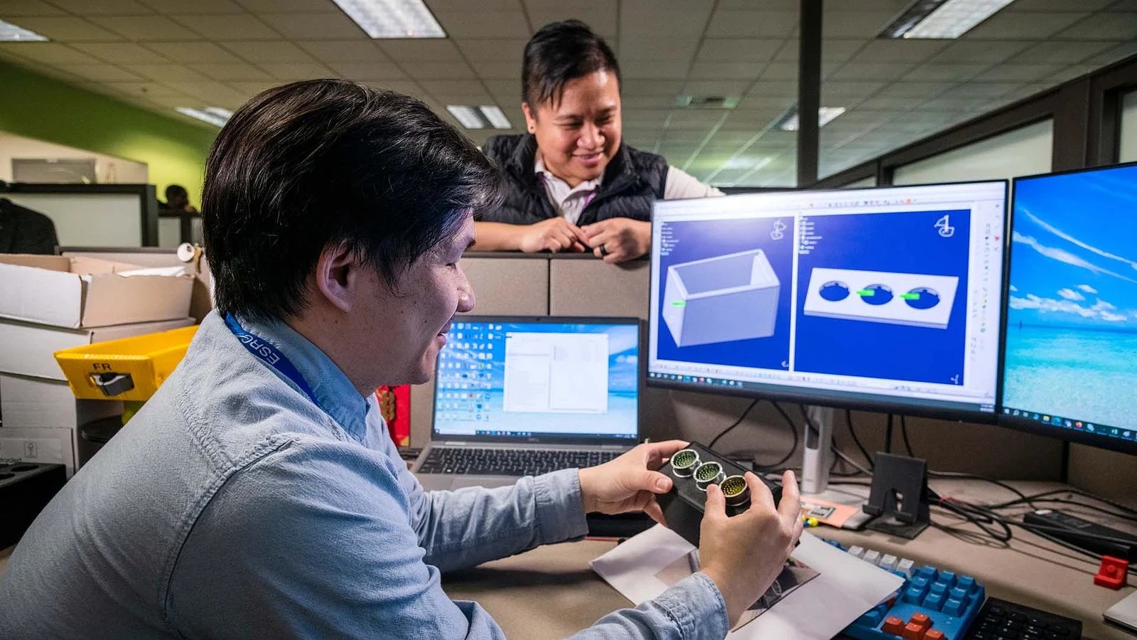 Hazel Fernandez (right) discusses a prototype of a new 3D-printed solution with Jia Huang.