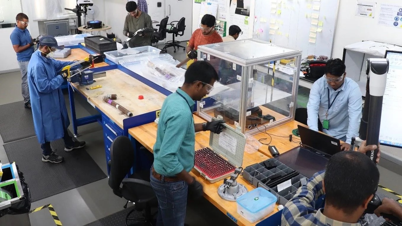 Boeing Technology Innovation teammates examine components in a teardown lab in Bengaluru, India.