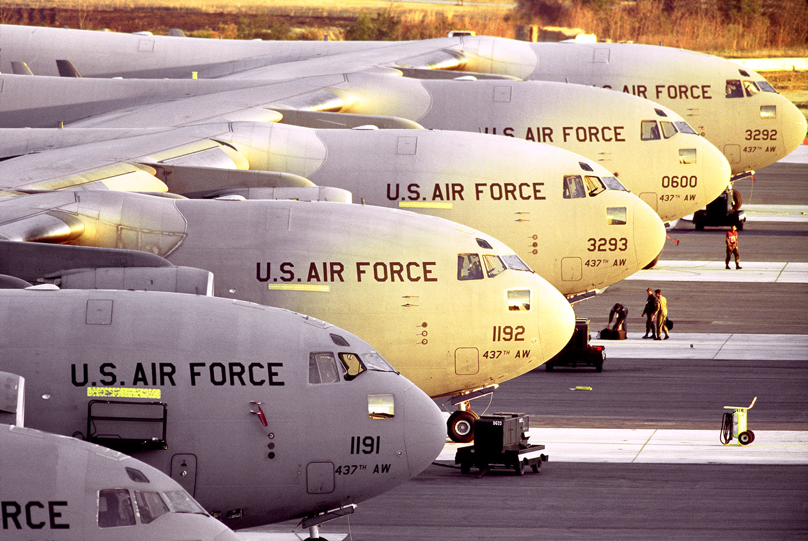 A row of C-17As sit on the flightline. 