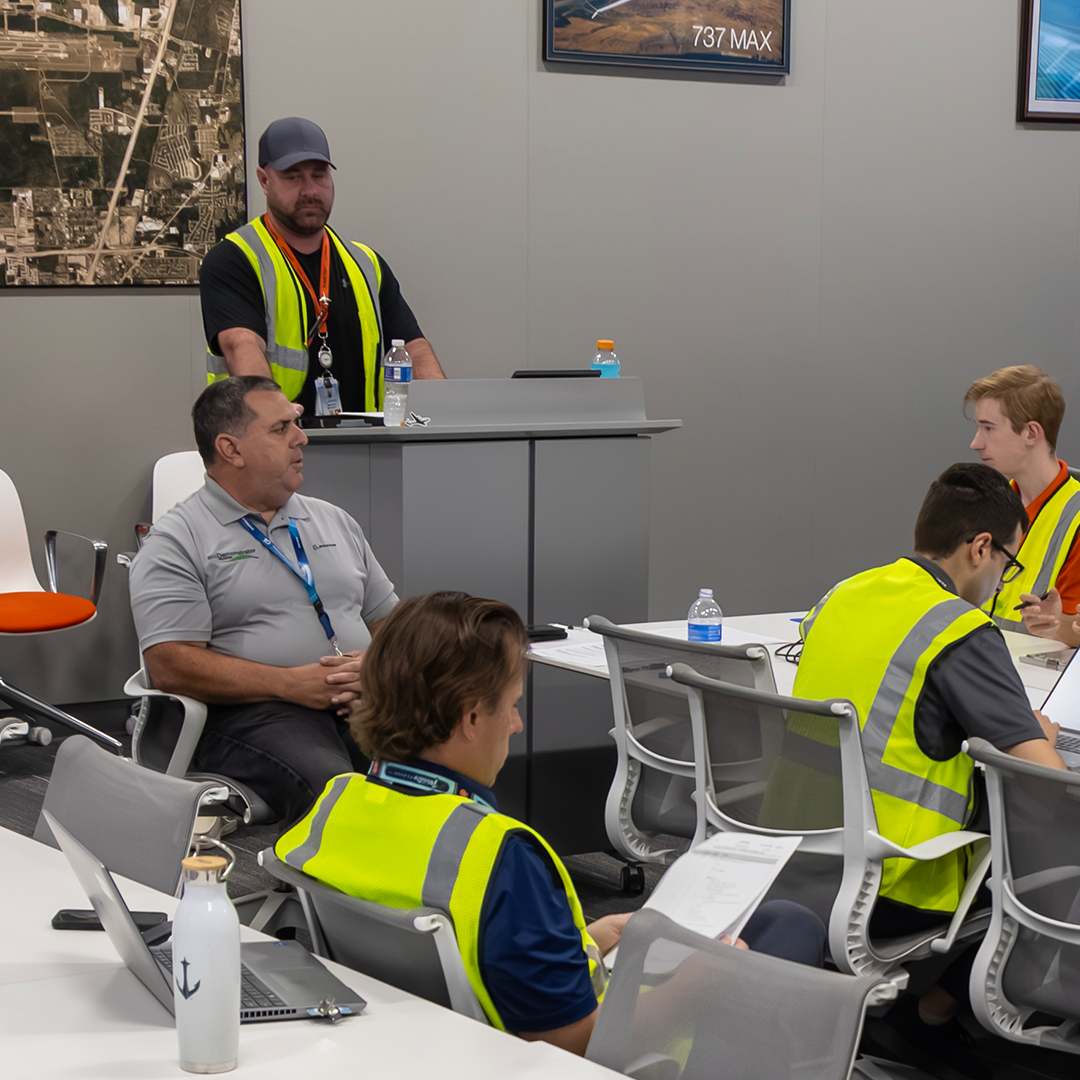  Mike Torres (sitting) and Mike McIntyre (podium) leading test team during a flight briefing. (photo Paul Weatherman © Boeing)