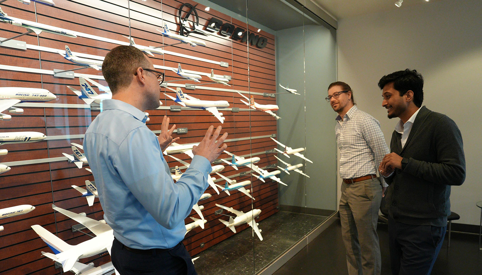 Pettit tells a story to Strefling and Gyawali, both of whom look on.