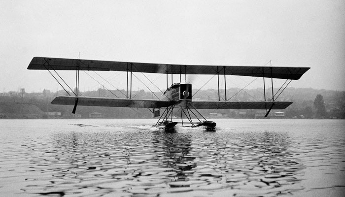 black and white image of B&W aircraft taxiing on Lake Washington