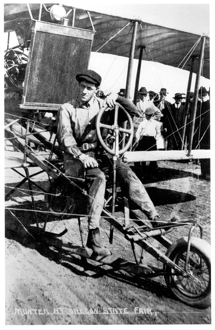 black and white image of man in vintage aircraft