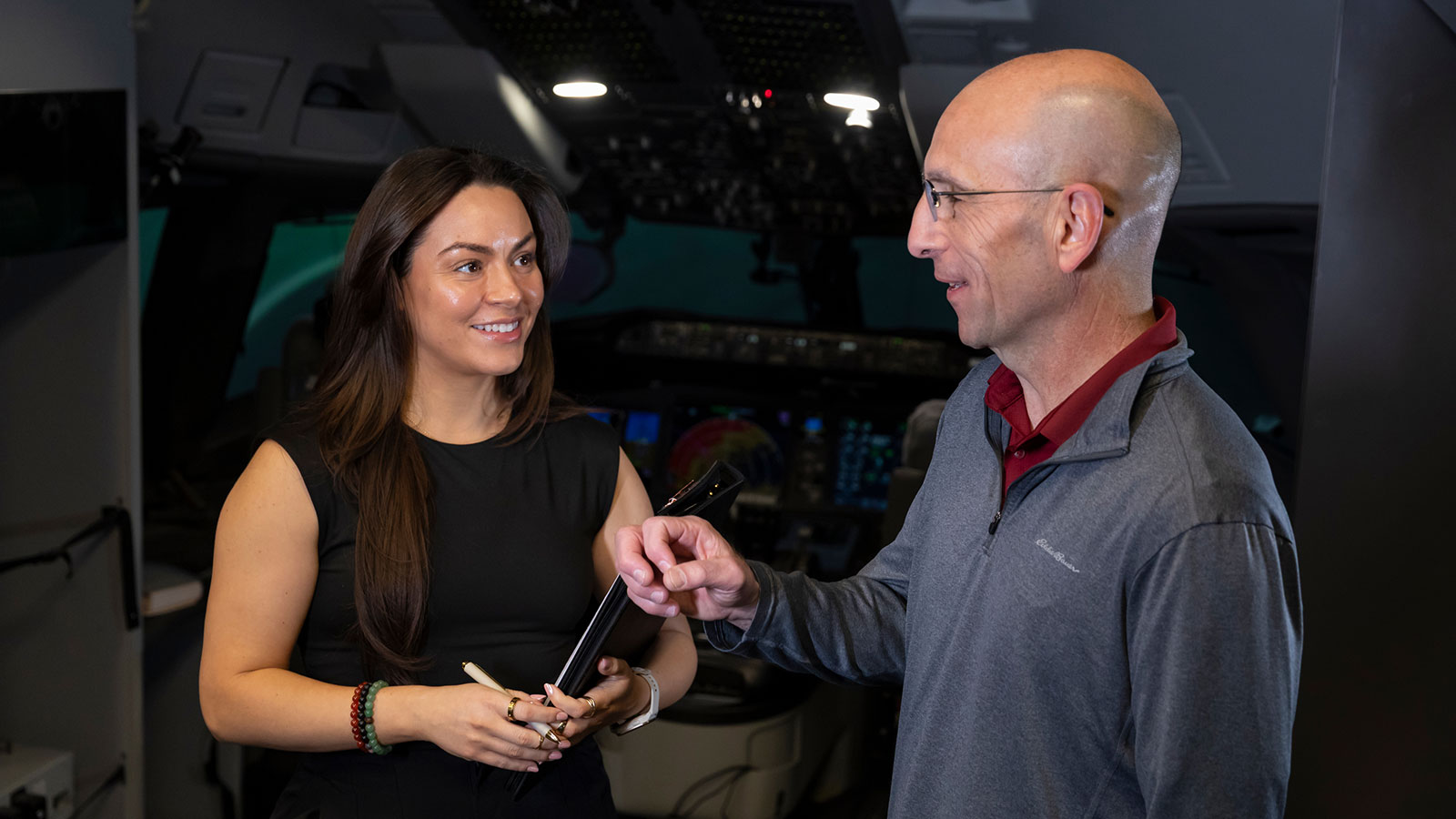 Two Boeing employees discuss simulator testing.