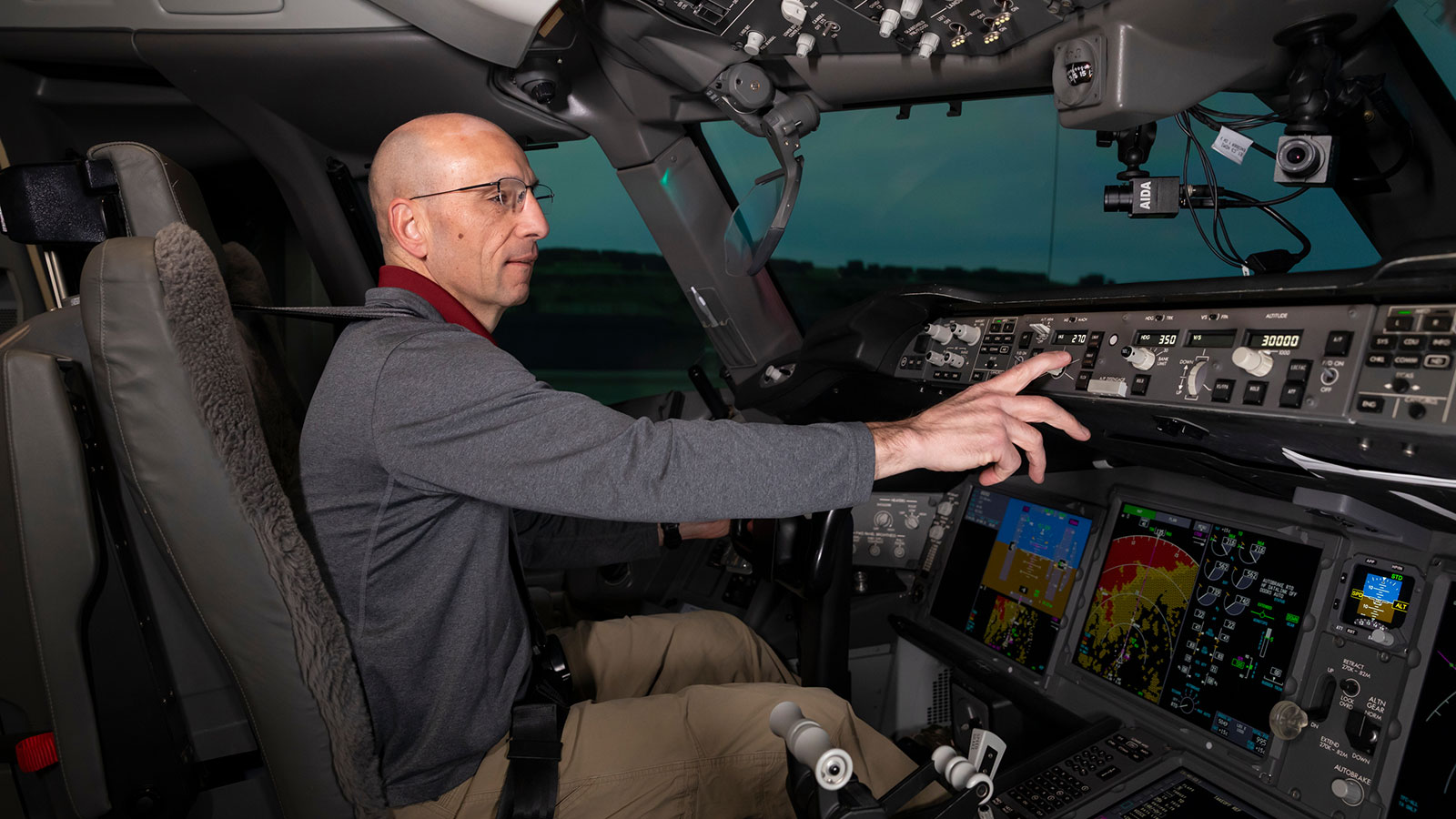A Boeing pilot is seated in an engineering simulator.