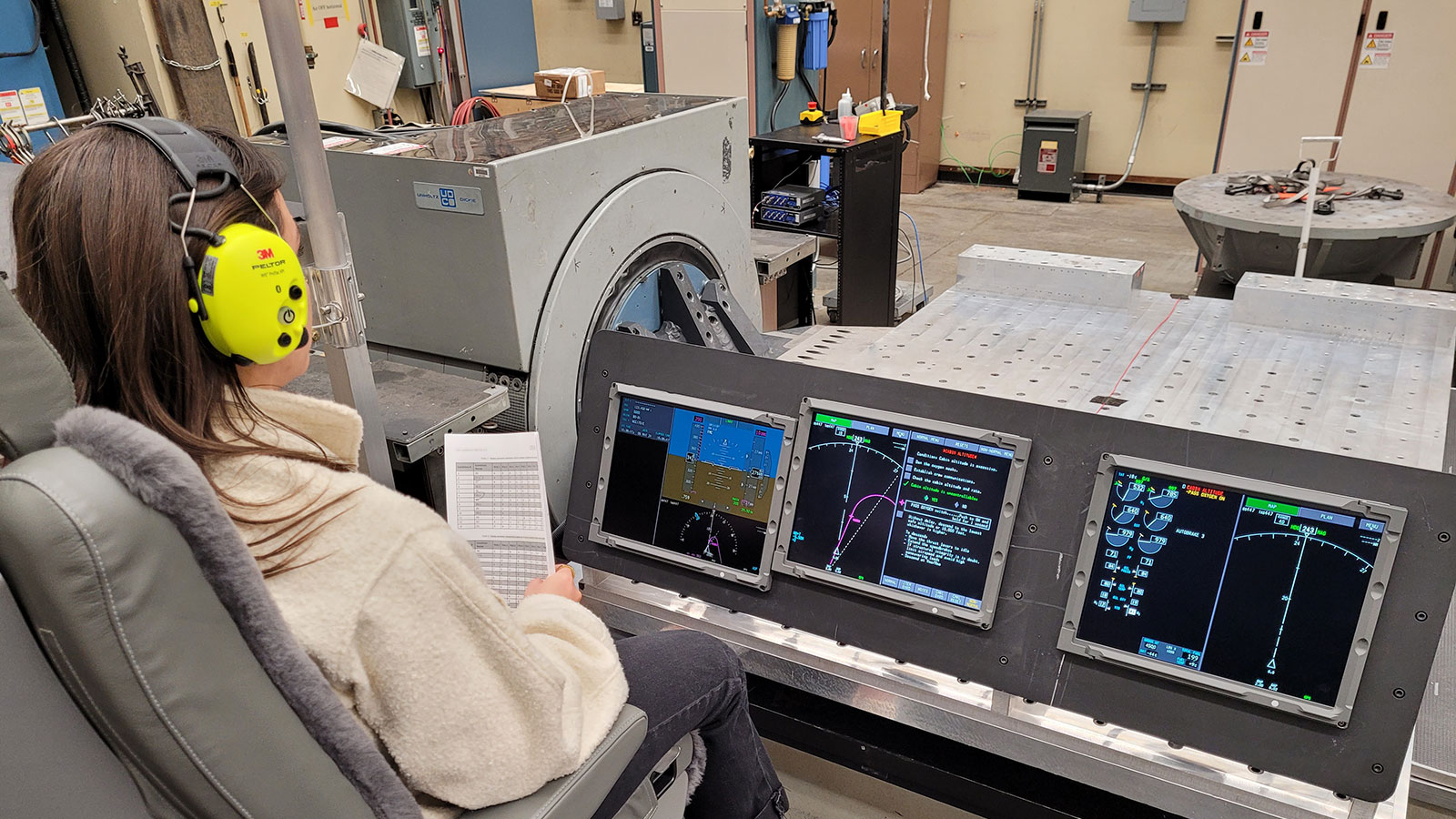 An employee views data displayed on screens.