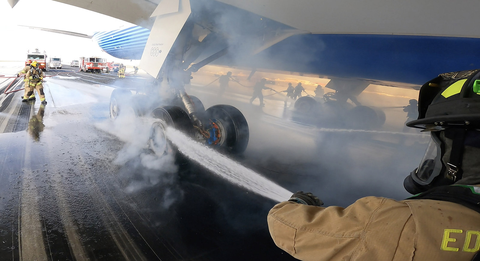Crews spray water on the 777-9’s wheels and brakes.