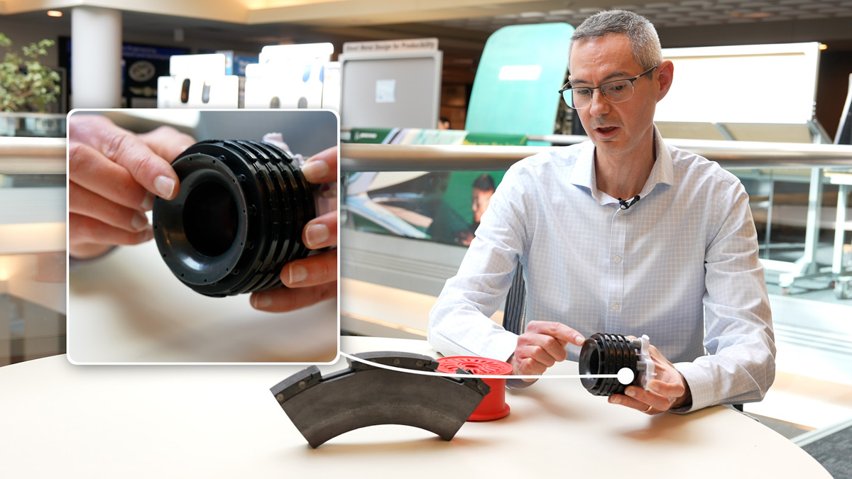 Evan Preston, a wheel, tire and brake engineer, shows off models of the 737-10’s enhanced brakes, which features a fifth composite rotor for greater torque and braking force. (Photo: Vanessa Misciagna © Boeing)