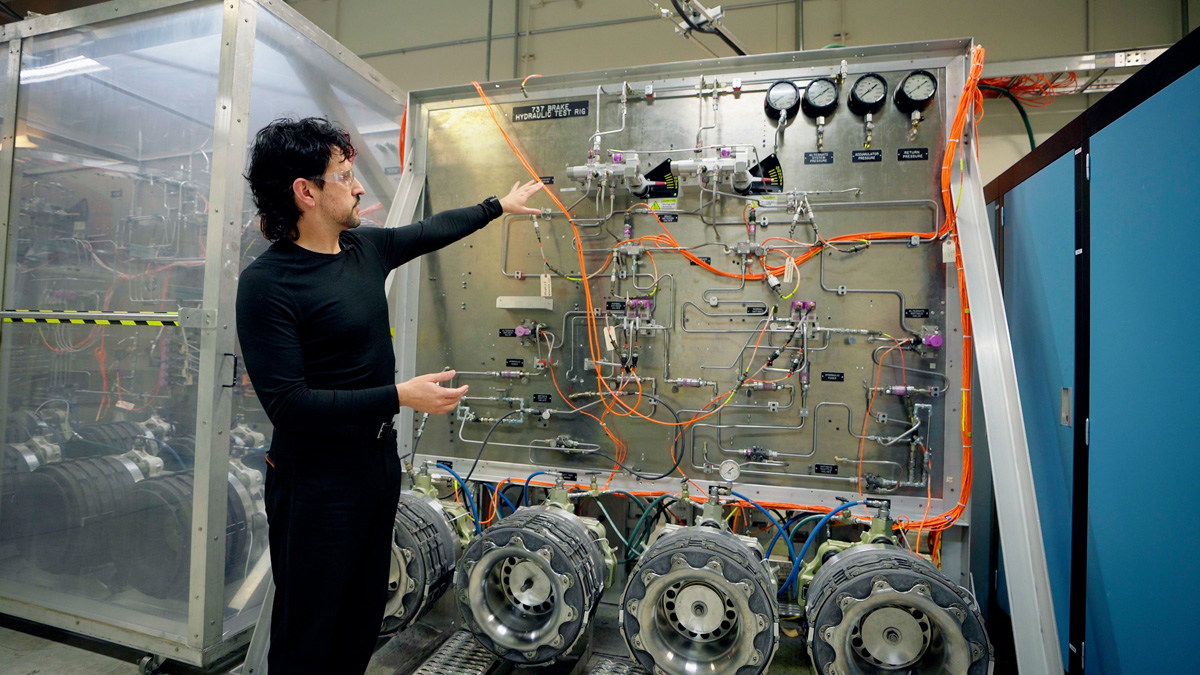  Nima Forghani, a brake systems engineer, shows off the 737 Brake Hydraulic Test Rig that the 737-10 development team used to test the enhanced braking system. (Photo: Wen Huber © Boeing)